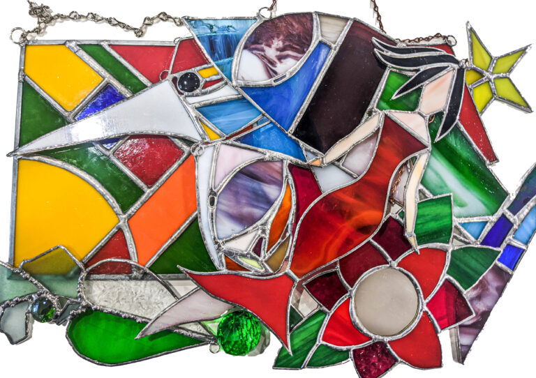 Colorful stained glass art featuring cats and geometric shapes.