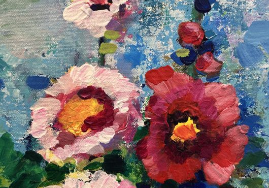 Vibrant close-up of pink and red flowers against a textured blue background.